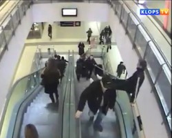Kid horsing around on escalator takes nasty fall